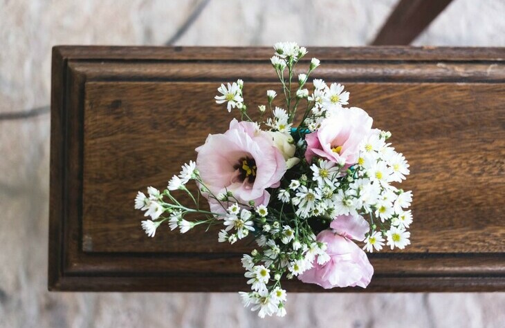 Casket with pink roses on top